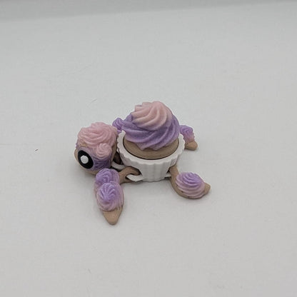 Birthday cupcake turtle key clicker fidget with pink and purple frosting shell in white liner, side view, 3D printed