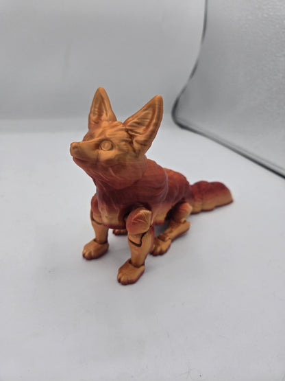 Flexi fennec fox figurine in red and gold gradient standing and looking up, articulated 3D print