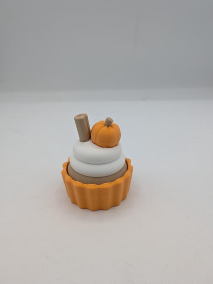 Pumpkin spice cupcake clicker fidget with mini pumpkin and cinnamon stick topper in an orange tin