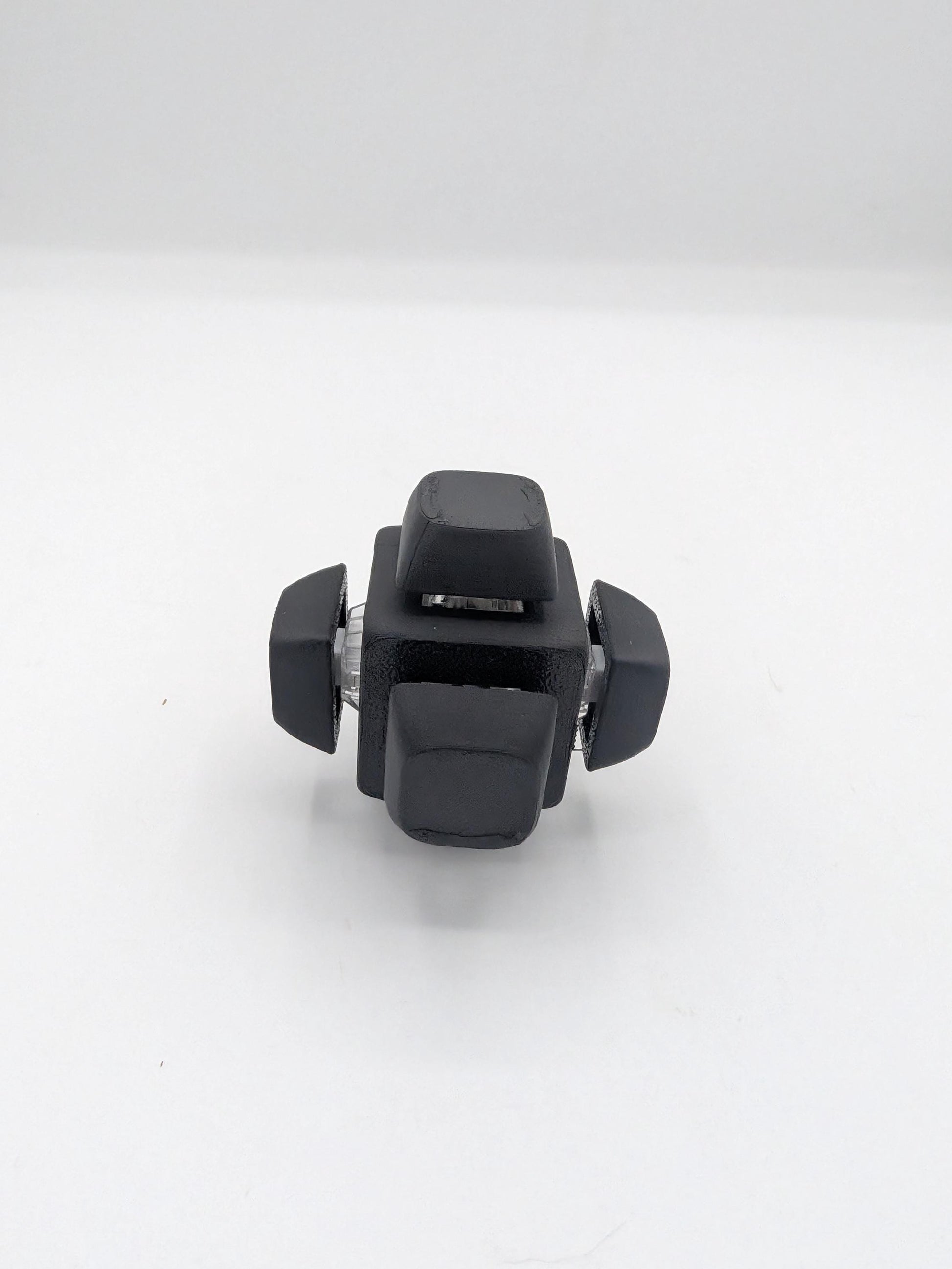 Angled view of black clicker cube key switch fidget showing keycaps and clear switch housings, 3D printed