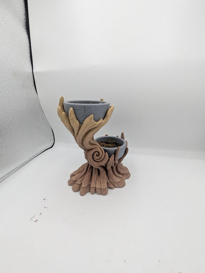 Side view of the spiral tree dual planter showing the swirled trunk detail and rooted base, upper bowl empty and lower bowl holding faux moss