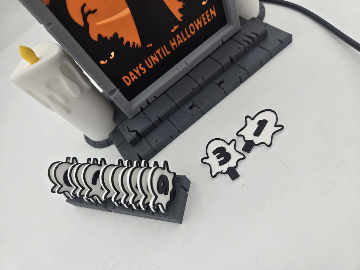 Vampire Halloween Countdown swappable ghost number tiles — spare tiles stacked in the storage rack with the 3 and 1 tiles laid out beside it
