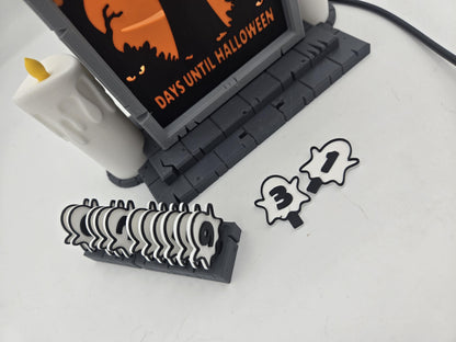 Vampire Halloween Countdown swappable ghost number tiles — spare tiles stacked in the storage rack with the 3 and 1 tiles laid out beside it