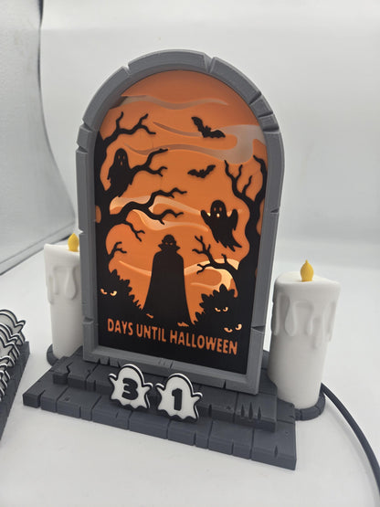 Vampire Halloween Countdown 3D print angled view — gray tombstone frame, layered orange scene, two dripping-wax style candles, and ghost number tiles reading 31