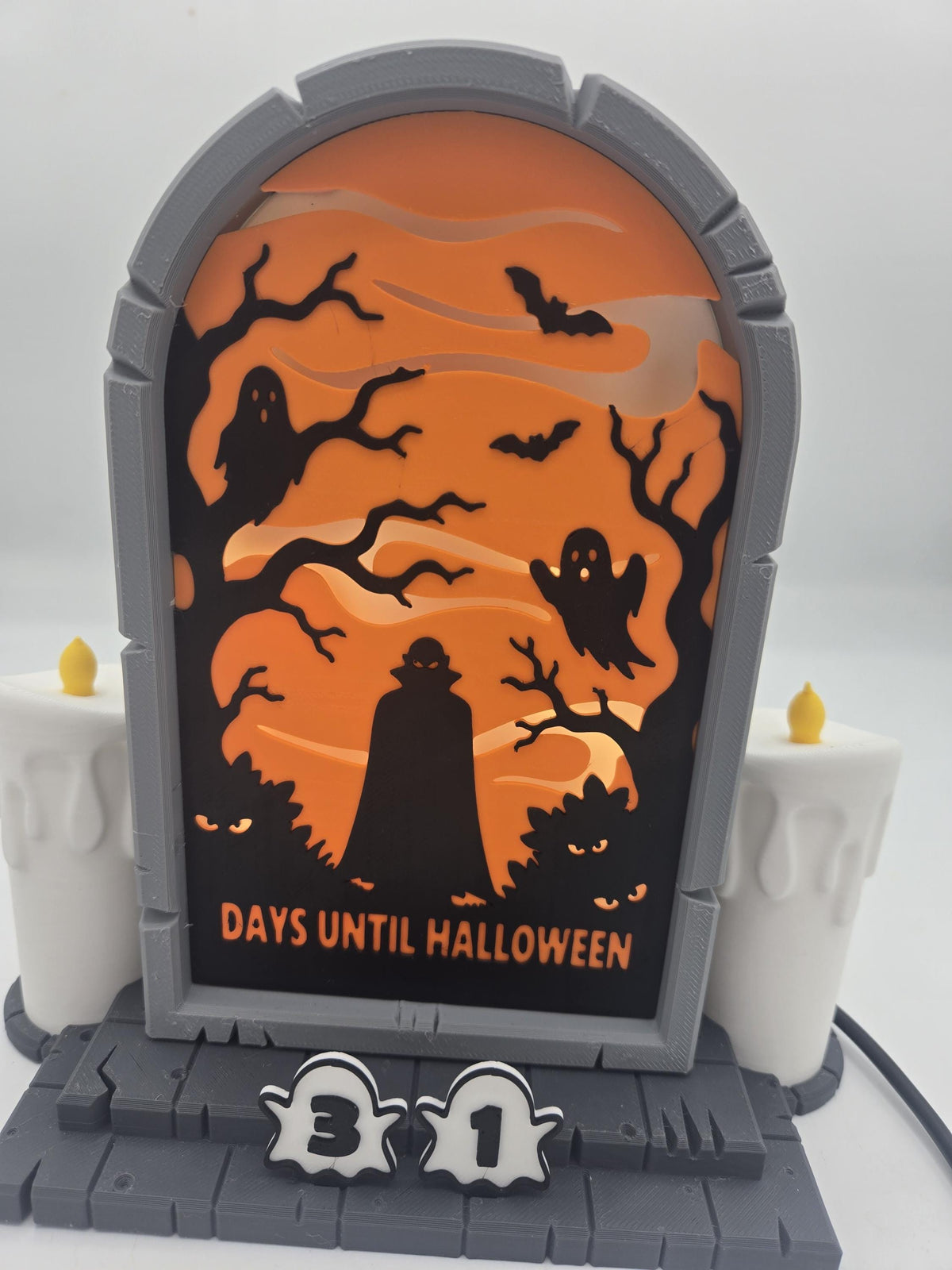 Vampire Halloween Countdown front close-up — caped vampire silhouette among glowing-eyed bushes with Days Until Halloween text and ghost number tiles