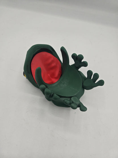 Frog Can Cover 3D print underside view — open mouth showing the red interior and the curved jaw that clips over the can rim, with splayed webbed feet