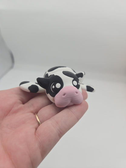 Sea Cow Manatee flexi 3D print held in palm, face close-up showing big cute eyes, black ears, and baby pink nose