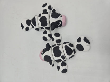 Two Sea Cow Manatee flexi 3D prints flat lay from above, showing black and white cow spots, pink noses, and articulated joints