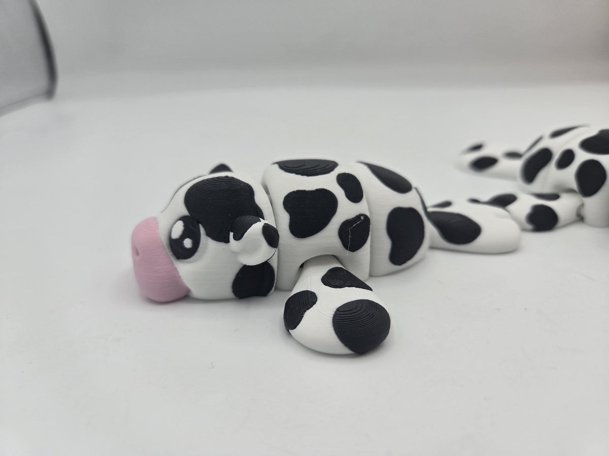 Sea Cow Manatee flexi 3D print side view with a second manatee behind, showing articulated flippers and cow-spot pattern
