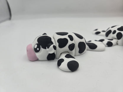 Sea Cow Manatee flexi 3D print side view with a second manatee behind, showing articulated flippers and cow-spot pattern