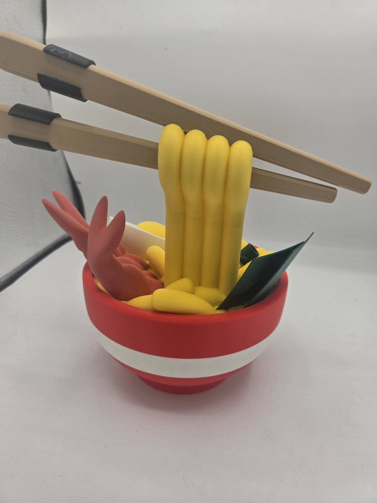 Ramen Bowl Display and Stash 3D print rear view showing the back of the noodle strands under the chopsticks, shrimp tails and seaweed