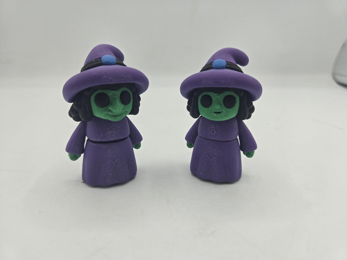 Tiny Witch Articulated Flexi Mini 3D print both nose styles standing upright on a white surface, front view in purple and green