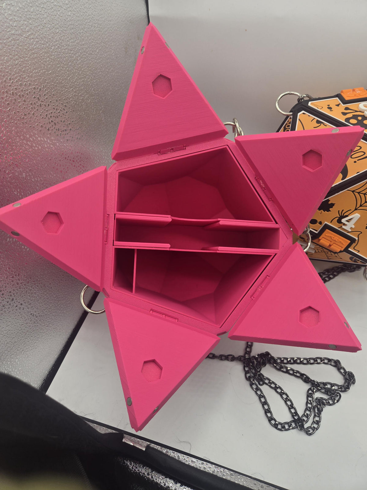 D20 Dice Shaped Purse 3D print in pink opened flat with the five triangular panels folded out, showing the hexagonal interior fitted with a modular organizer insert