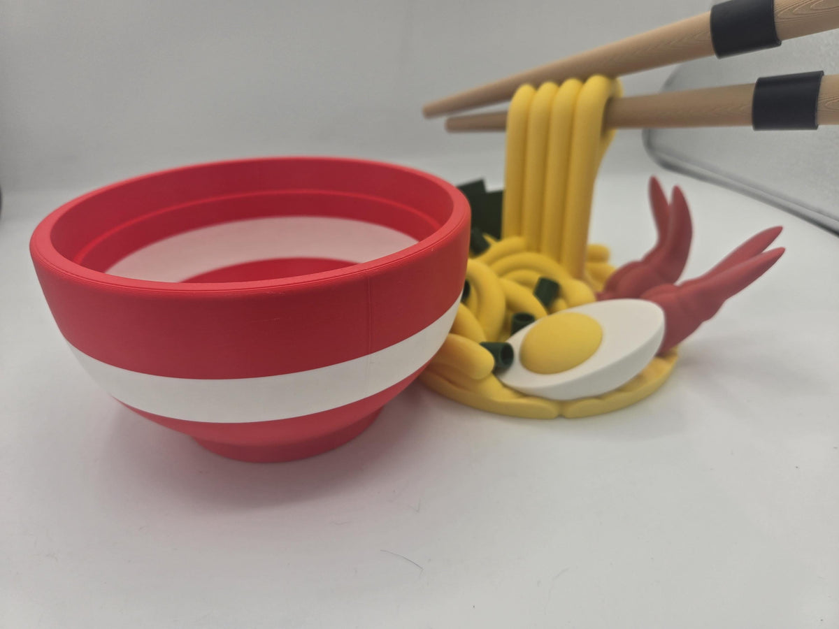 Ramen Bowl Display and Stash 3D print empty red bowl with white stripe in front, the removable noodle and egg topper behind it