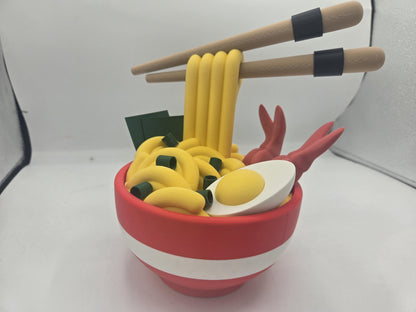 Ramen Bowl Display and Stash 3D print assembled, angled front view with the egg half, shrimp and seaweed detail on the yellow noodles