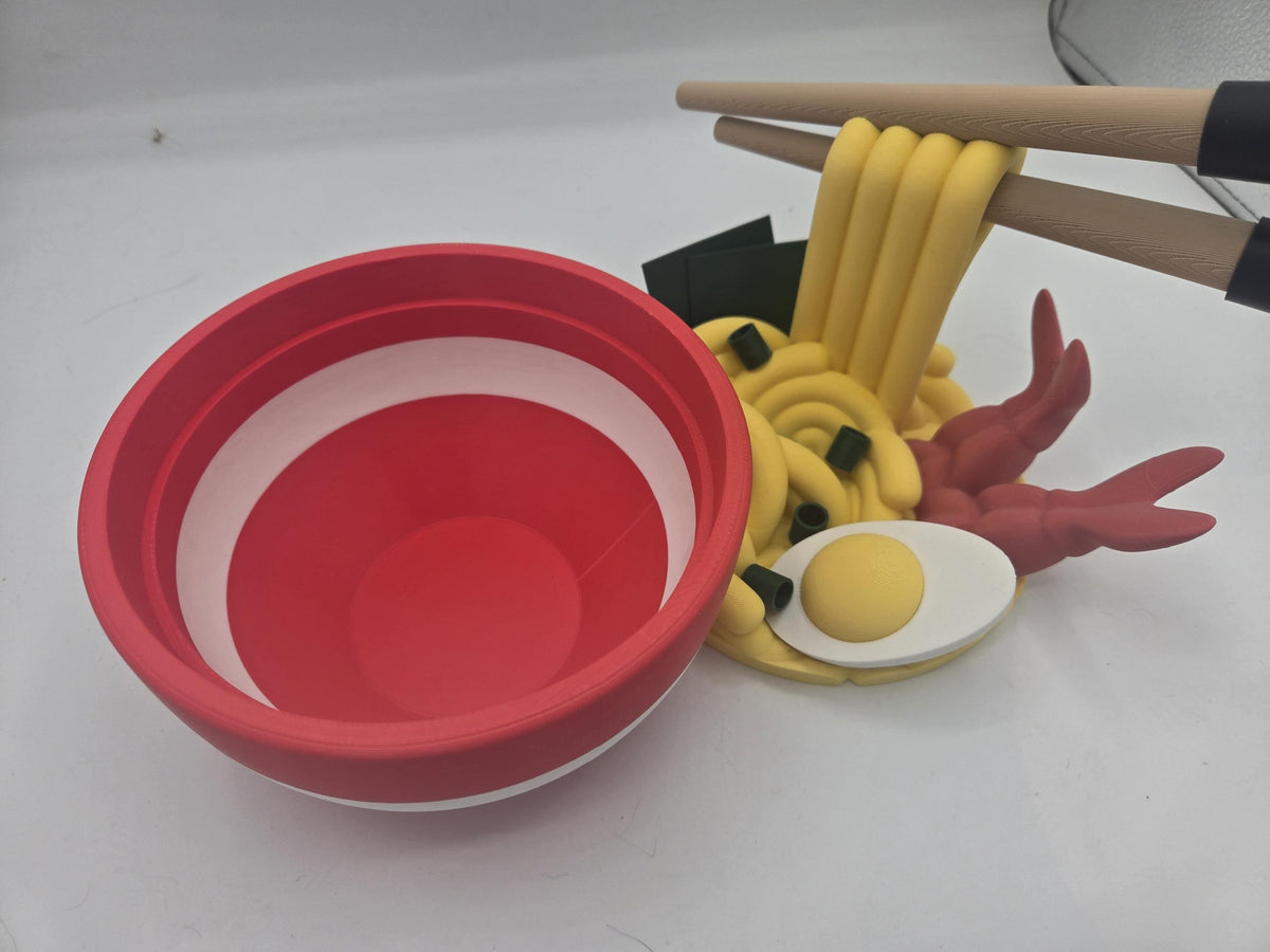 Ramen Bowl Display and Stash 3D print with the red bowl separated from the noodle topper, showing the empty stash interior and white rim stripe