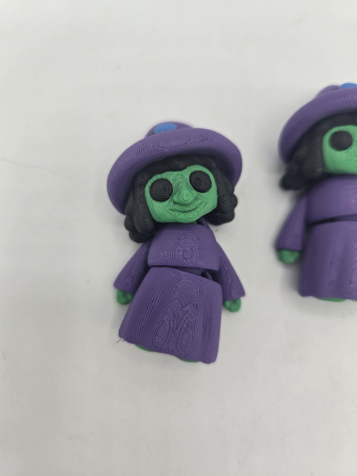 Tiny Witch Articulated Flexi Mini 3D print close-up of the long-nose witch face, showing the hooked nose, grin and articulated robe joints