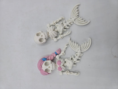 Flexi Mermaid Skeleton 3D print top view of the plain and Hair + Clam Shells styles laid out flat, poseable arms and segmented skeletal tails