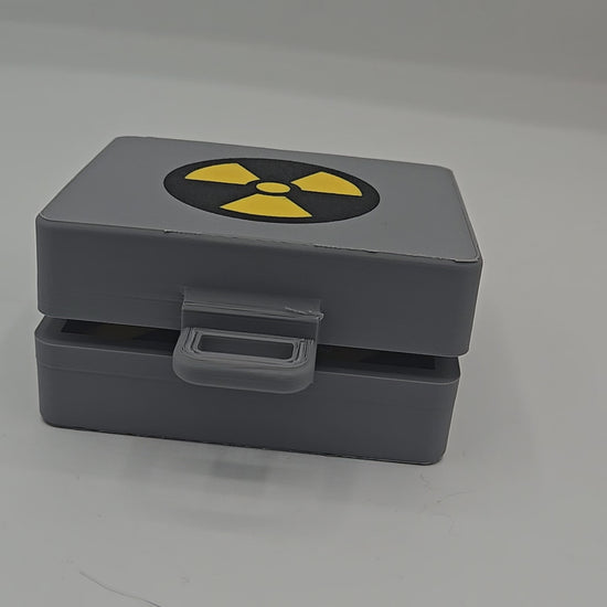 Top Secret Briefcase Nuclear Mechanical Key Fidget Clicker 3D print video — gray briefcase with radiation symbol lid and latch, opened to reveal the red NUKE clicker button