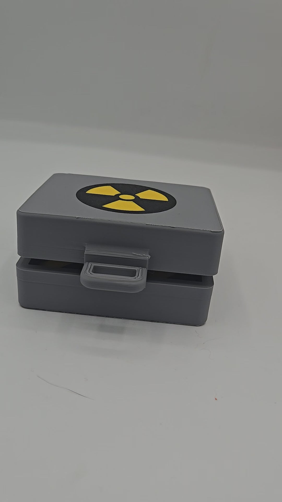 Top Secret Briefcase Nuclear Mechanical Key Fidget Clicker 3D print video — gray briefcase with radiation symbol lid and latch, opened to reveal the red NUKE clicker button