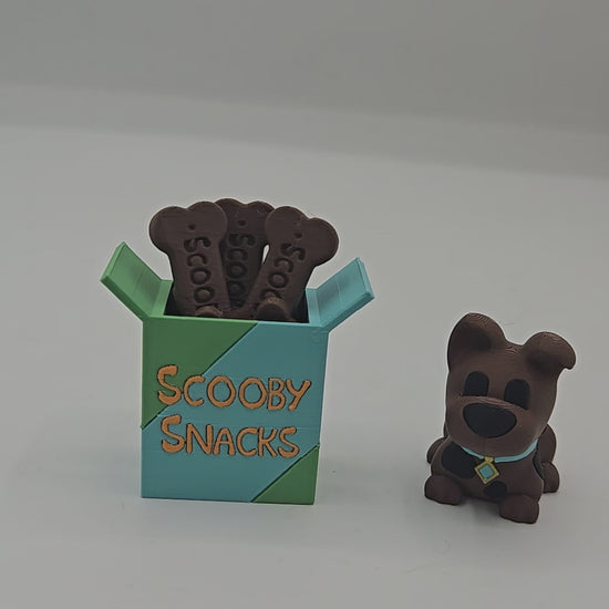 Video of the Scooby Snacks key clicker and mini Scooby Doo inspired dog figurine 3D print set on a desk