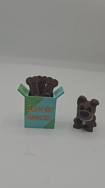 Video of the Scooby Snacks key clicker and mini Scooby Doo inspired dog figurine 3D print set on a desk